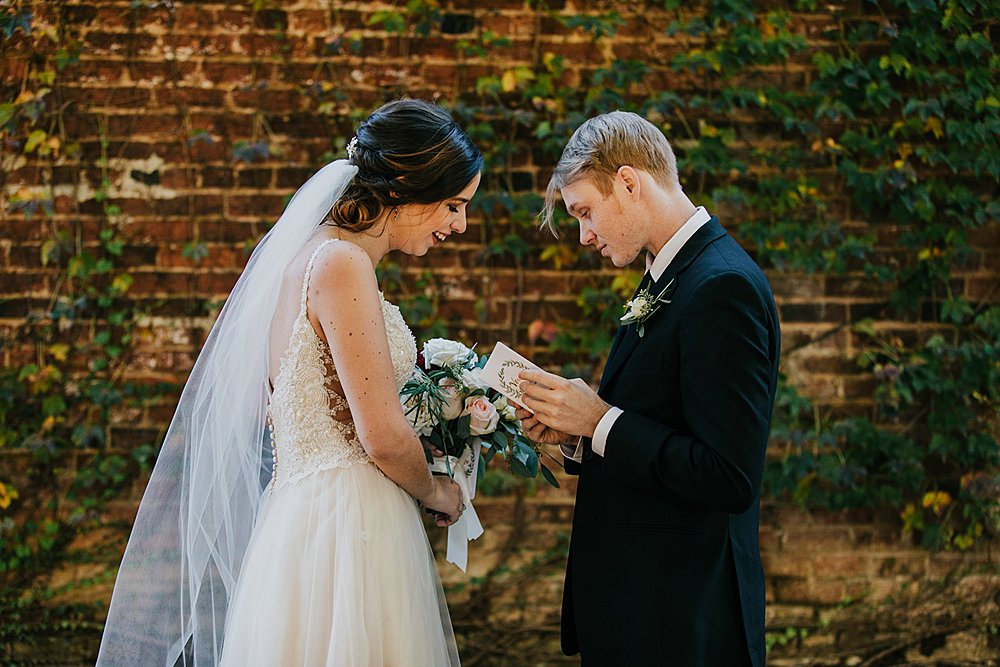 couple exchanging private vows during the first look