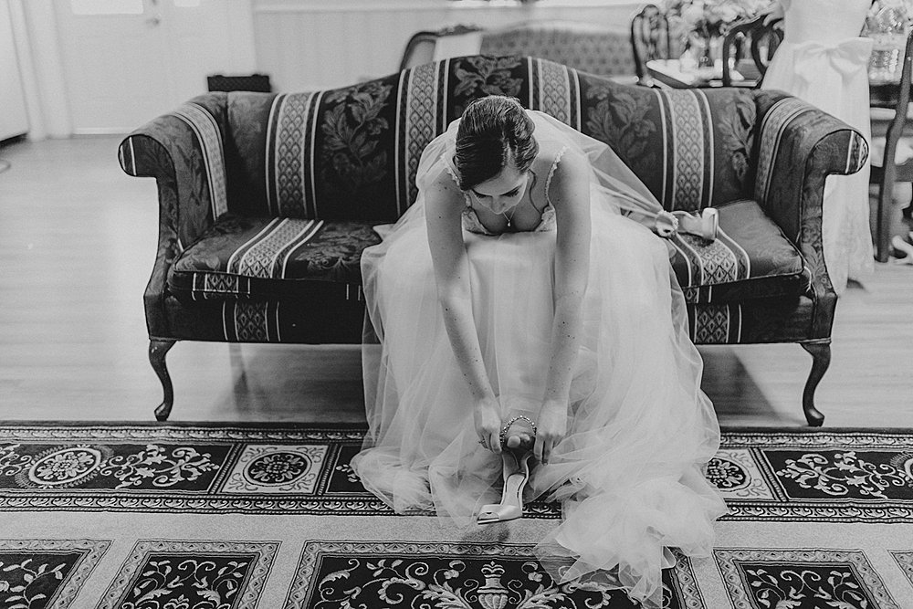 Bride putting the finishing touches on getting dressed for her fall wedding at the Silk Mill