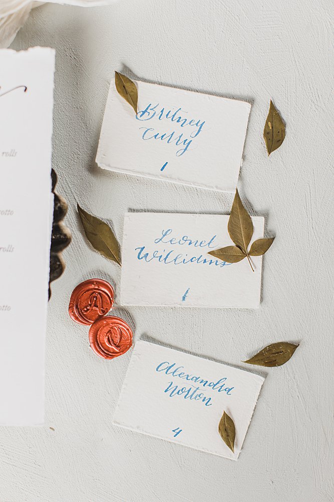 escort cards greenery and wax seals for a summer wedding