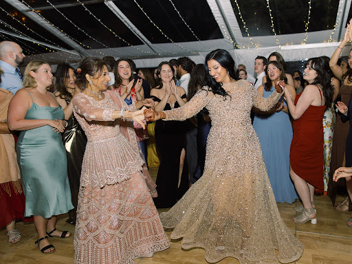 candid bride on dance floor with wedding guests